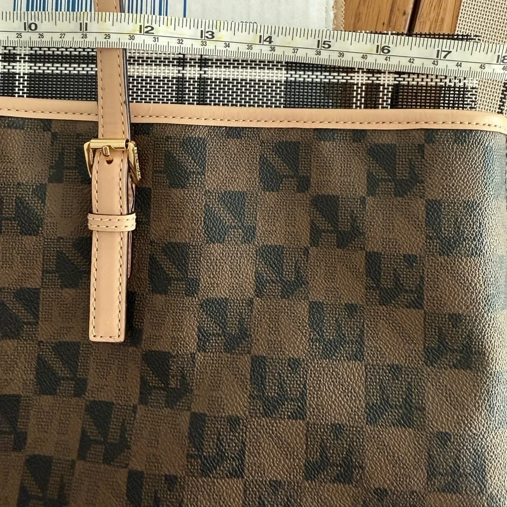 MICHAEL Michael Kors Jet Set travel tote in a brown checkered monogram pattern.